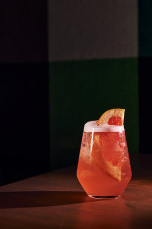 Grapefruit inside. Close up view of fresh summer cocktail on the wooden tableの写真素材