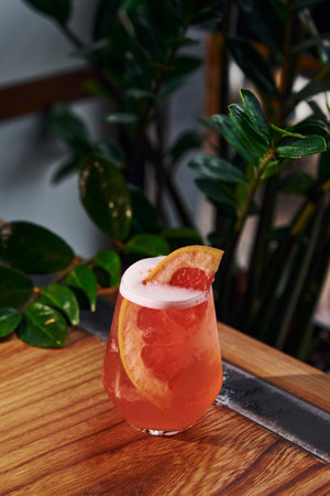 Grapefruit inside. Close up view of fresh summer cocktail on the wooden tableの写真素材