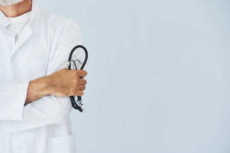 Close up view of male doctor in coat that holding stethoscopeの写真素材