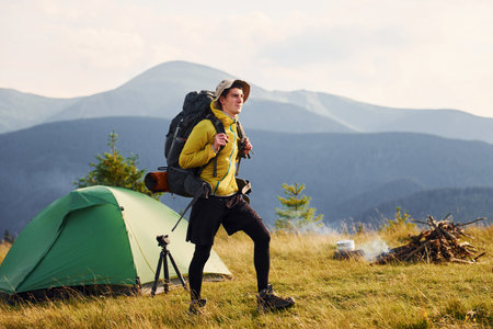 Young male traveler have a walk. Majestic Carpathian Mountains. Beautiful landscape of untouched natureの写真素材