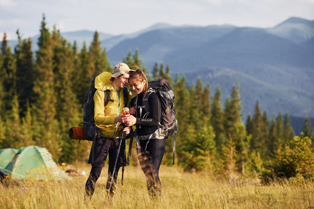 Cute young couple. Majestic Carpathian Mountains. Beautiful landscape of untouched natureの写真素材