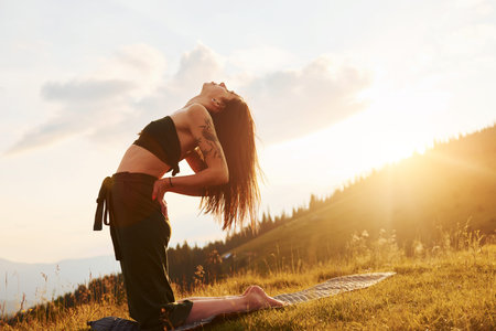 Doing yoga outdoors. Beautiful woman. Majestic Carpathian Mountains. Beautiful landscape of untouched natureの写真素材