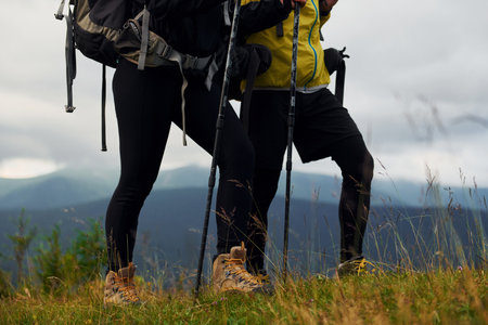 Hiking together. Woman and man. Majestic Carpathian Mountains. Beautiful landscape of untouched natureの写真素材
