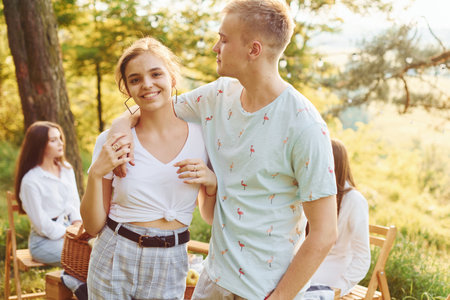 Happy couple. Group of young people have vacation outdoors in the forest. Conception of weekend and friendshipの写真素材