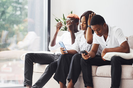 Group of african american business people on sofa in office togetherの写真素材