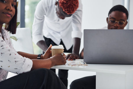 Thinking together. Group of african american business people working in office togetherの写真素材