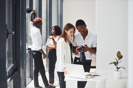 Looking at the camera. Group of african american business people working in office togetherの写真素材