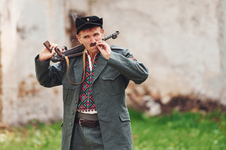 TERNOPIL, UKRAINE - June 2020 UPA Ukrainian Insurgent Army movie filming. Pictures of backstage. Old soldier with weapon smokingのeditorial素材