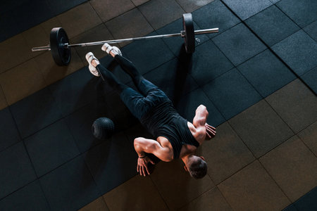 Top view of strong man in sportive clothes that have workout day in the gymの写真素材