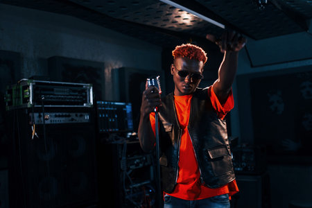 Young african american performer rehearsing in a recording studioの写真素材