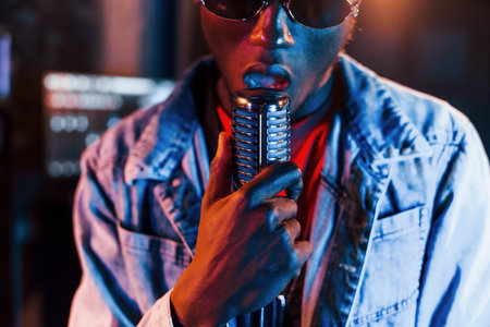 Young african american performer rehearsing in a recording studioの写真素材