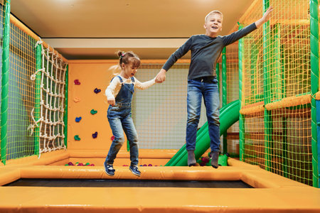 Happy kids in casual clothes have fun in childrens game complexの写真素材