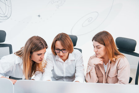Front view of group of business women in formal clothes indoors in the officeの写真素材