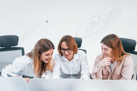 Front view of group of business women in formal clothes indoors in the officeの写真素材