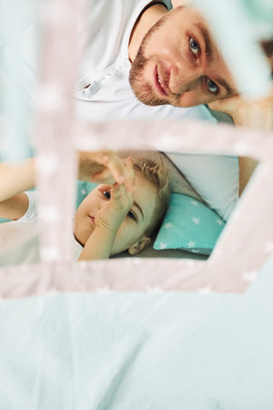 Father and his young young spending time together inside of tentの写真素材