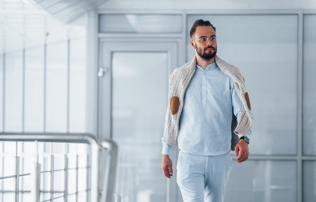 Young handsome man in formal clothes indoors in the office at daytimeの写真素材