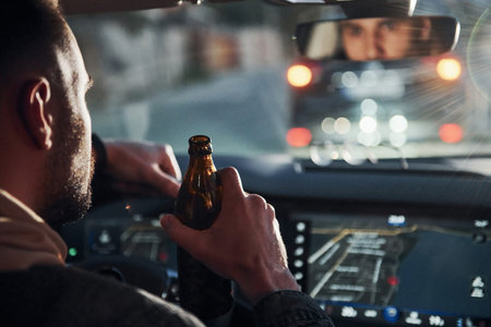 Dont drink and drive. Rear view of handsome unshaved man in fashionable clothes inside his...