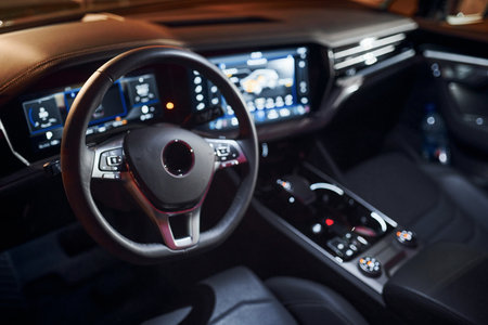 Steering wheel and navigation display. Close up view of front park of new modern black automobileの写真素材