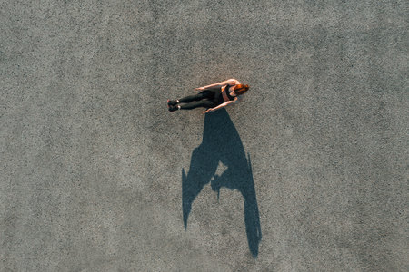 Top view of woman that have fitness day on the road at eveningの写真素材