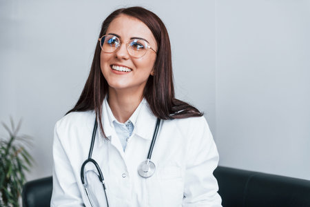 Friendly young nurse indoors in modern clinic ready to help youの写真素材