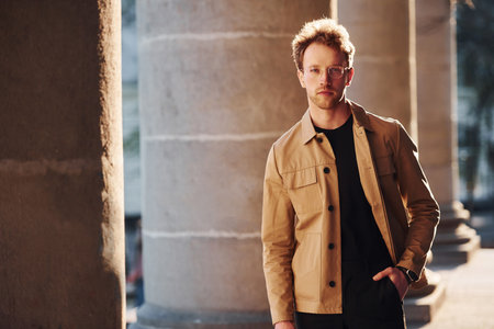 Elegant young man in formal classy clothes outdoors in the cityの写真素材