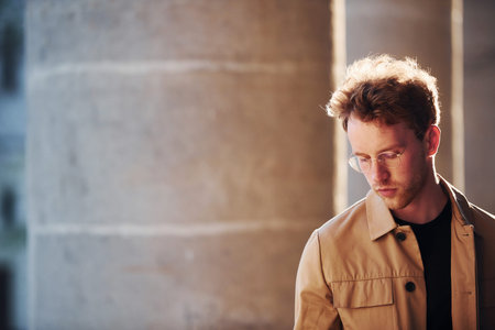Elegant young man in formal classy clothes outdoors in the cityの写真素材