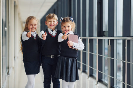School kids in uniform together in corridor. Conception of educationの写真素材