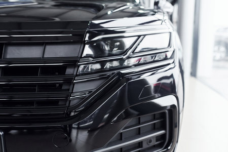 Particle close up view of modern new black automobile that parked indoorsの写真素材