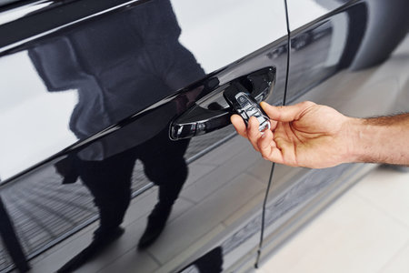 Close up view of mans hand that holds automobile keys