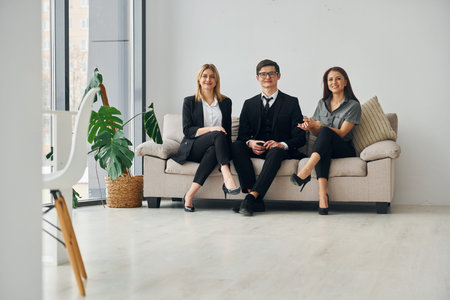 Group of people in official formal clothes that is indoors in the office