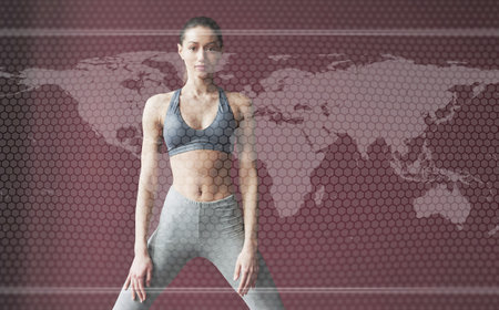 Digital world map on picture. Young woman with slim body shape in sportswear have fitness day indoorsの写真素材