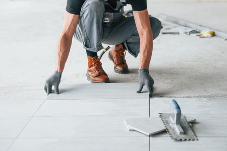 Man in grey uniform works indoors in modern big office at daytimeの写真素材
