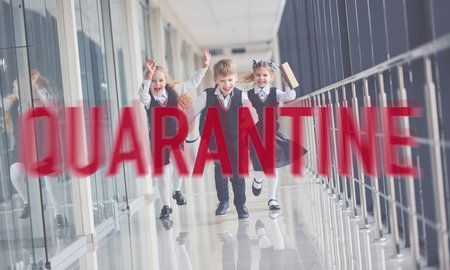 Red quarantine word. Group of kids in school uniform running together indoorsの写真素材
