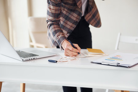 Close up view. Young stylish businessman in suit indoors. Conception of successの写真素材