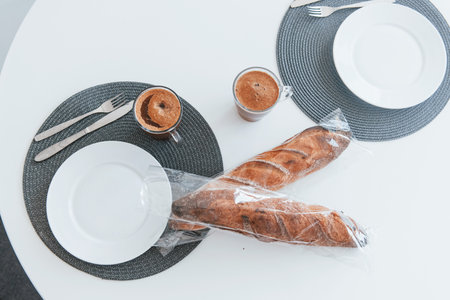 Close up view of table with empty plates, glasses with coffee and mealの写真素材