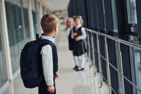 School kids in uniform together in corridor. Conception of educationの写真素材