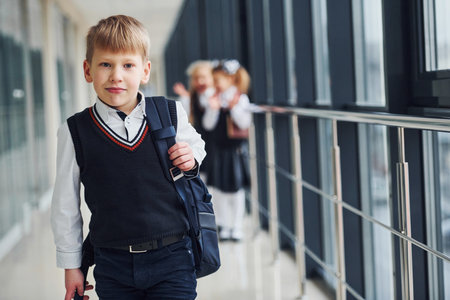 School kids in uniform together in corridor. Conception of educationの写真素材