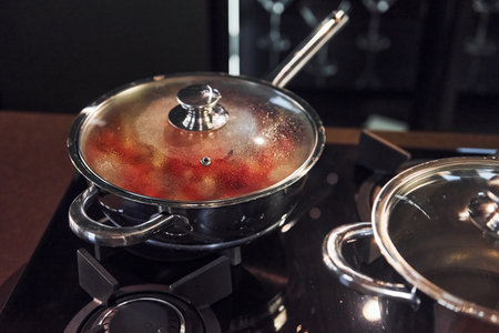 Preparing of the food on kitchen at daytime on gas stoveの写真素材