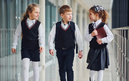 School kids in uniform together in corridor. Conception of educationの写真素材