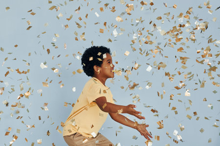 Happy little african american kid have fun indoors at birthday partyの写真素材