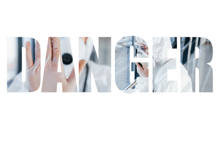 Danger word with human inside in protective wear that standingの写真素材