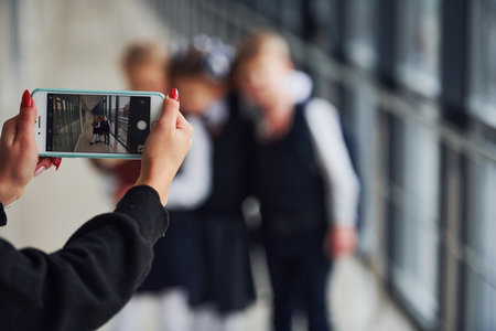 School kids in uniform making a photo together in corridor. Conception of educationの写真素材