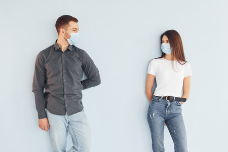 Man and woman standing indoors in the studio against white backgroundの写真素材