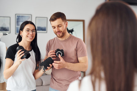 Preparing model. Photographers works indoors in their studio at daytimeの写真素材