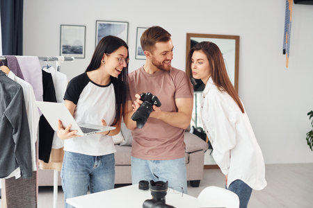 Preparing model. Photographers works indoors in their studio at daytimeの写真素材