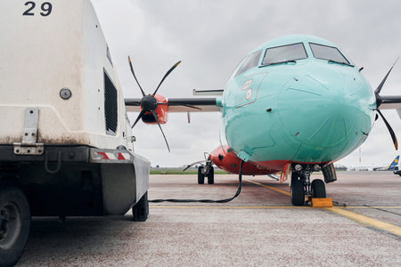 Turboprop aircraft parked on the runway at daytimeの写真素材