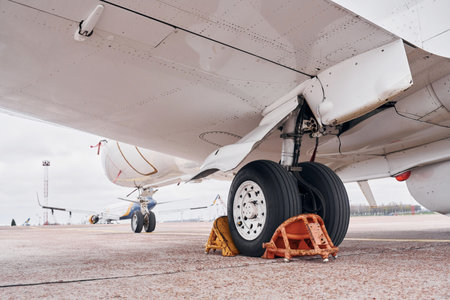 View from below. Turboprop aircraft parked on the runway at daytimeの写真素材