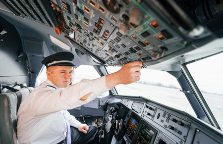 Control of the flight. Pilot on the work in the passenger airplane. Preparing for takeoffの写真素材