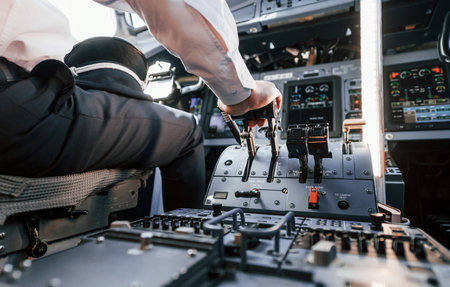 Control of the flight. Pilot on the work in the passenger airplane. Preparing for takeoffの写真素材
