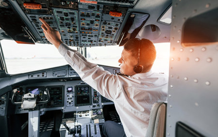 Control of the flight. Pilot on the work in the passenger airplane. Preparing for takeoffの写真素材
